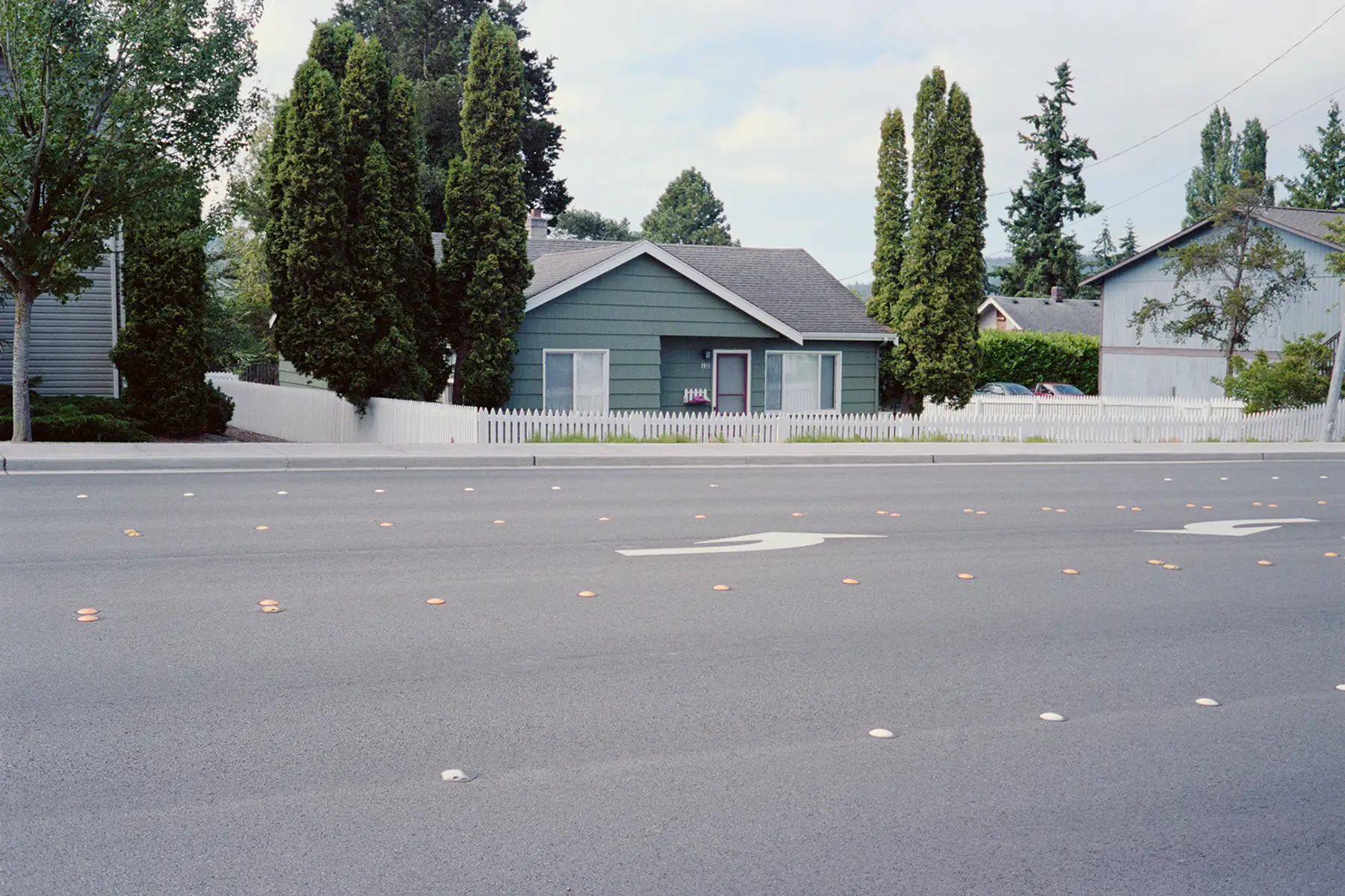 A small home across from a wide road in Bellingham, WA.