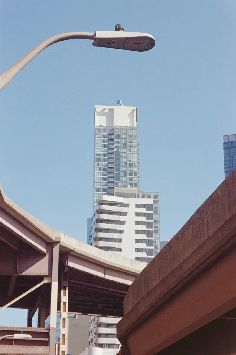 Skyscrapers tower behind on-ramps to the Queenboro Bridge.